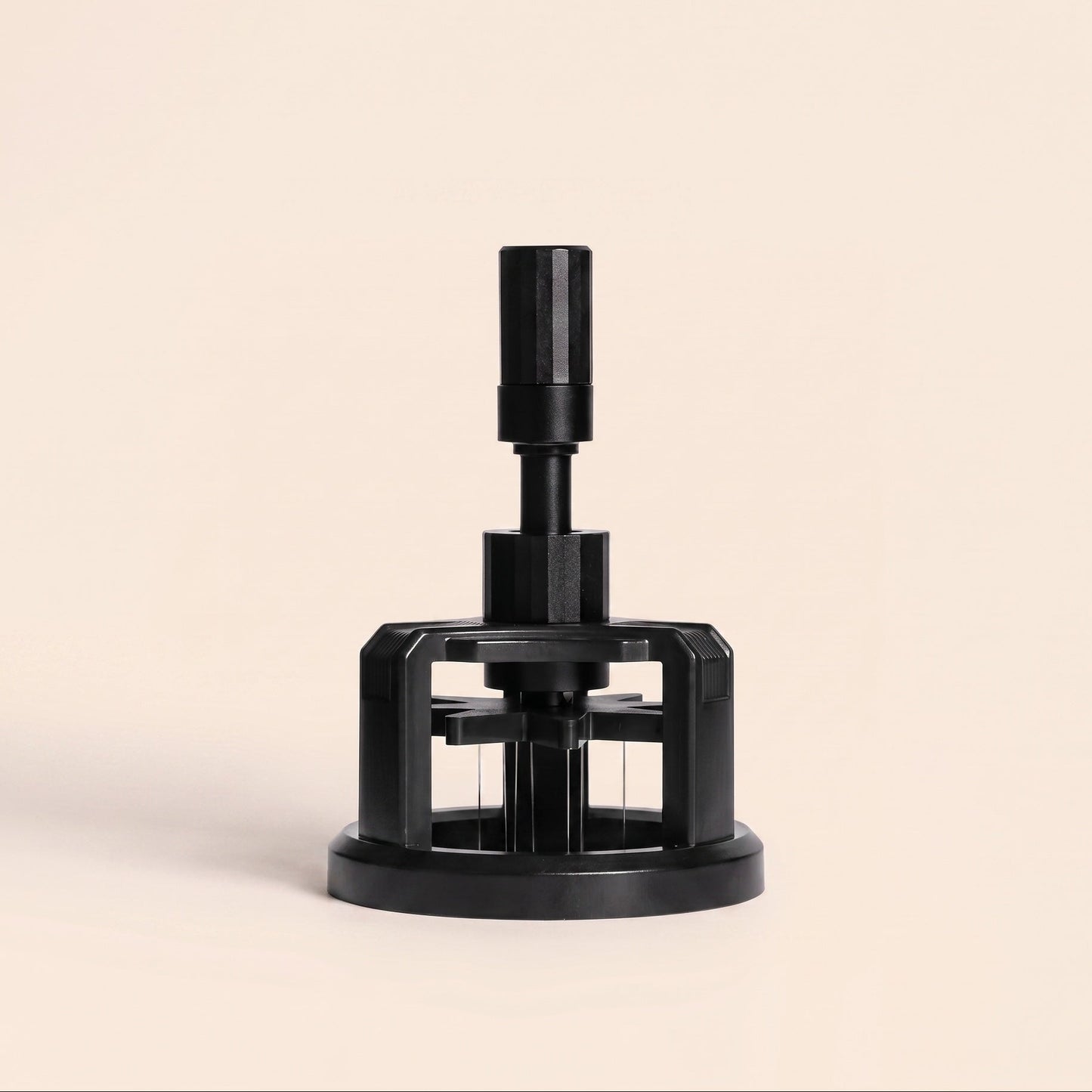 Rotary WDT tool with magnetic base on flat cream background, front view, black finish