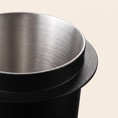 Close-up of the dosing cup flat rim flange and drawn seamless stainless interior