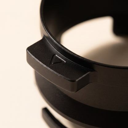 Dosing funnel side wings resting hands-free in a grinder cradle