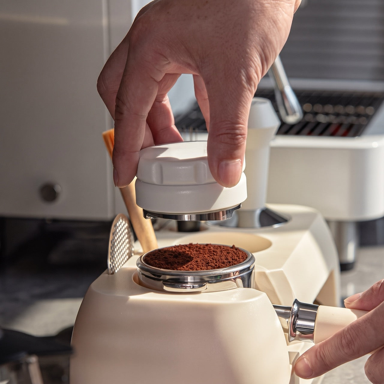 ABS tamping station with a portafilter cradled horizontally at 90 degrees