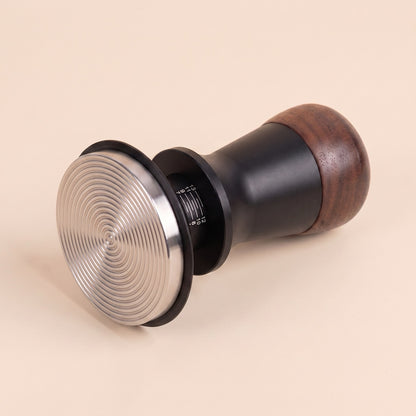 Calibrated tamper angled view showing the walnut handle and spring collar