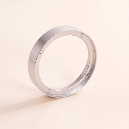 Magnetic dosing funnel seated on a portafilter basket rim while dosing
