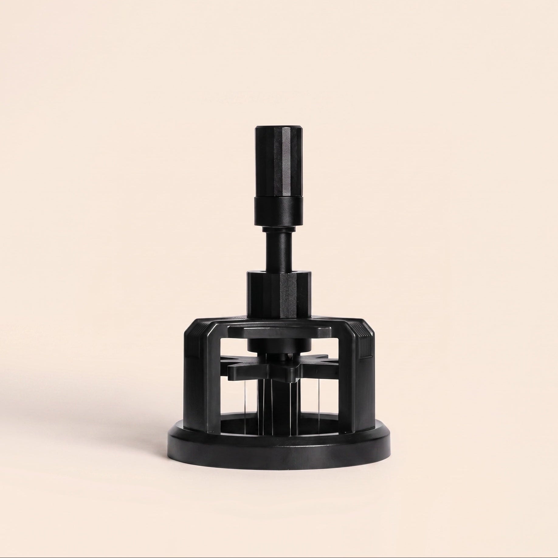 Rotary WDT tool with magnetic base on flat cream background, front view, black finish