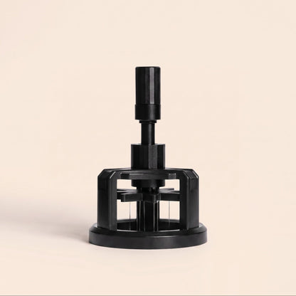 Rotary WDT tool with magnetic base on flat cream background, front view, black finish