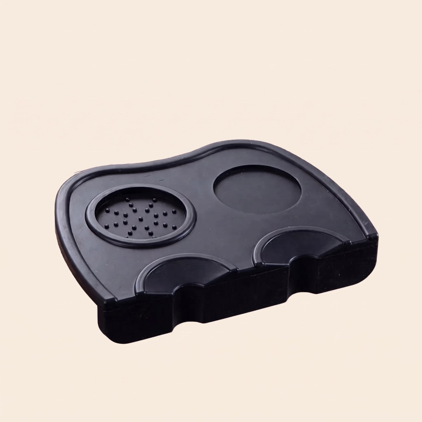Corner tamping mat in use with a tamper resting between shots
