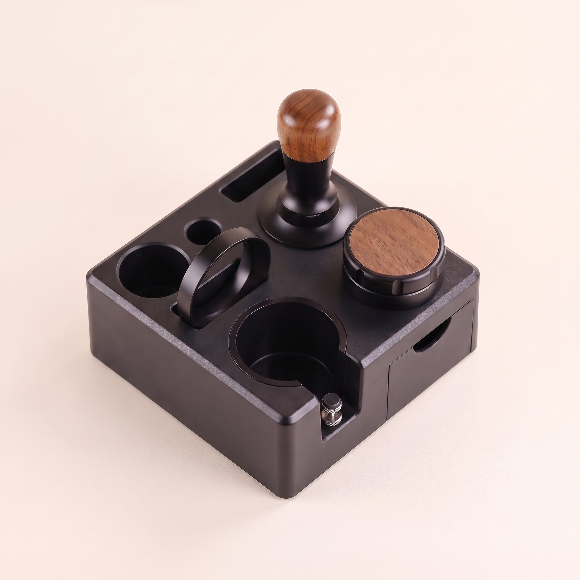 Tamping station with adjustable portafilter cradle, front view on a neutral background