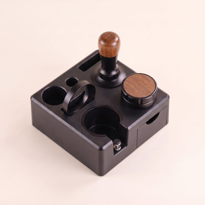 Tamping station with adjustable portafilter cradle, front view on a neutral background