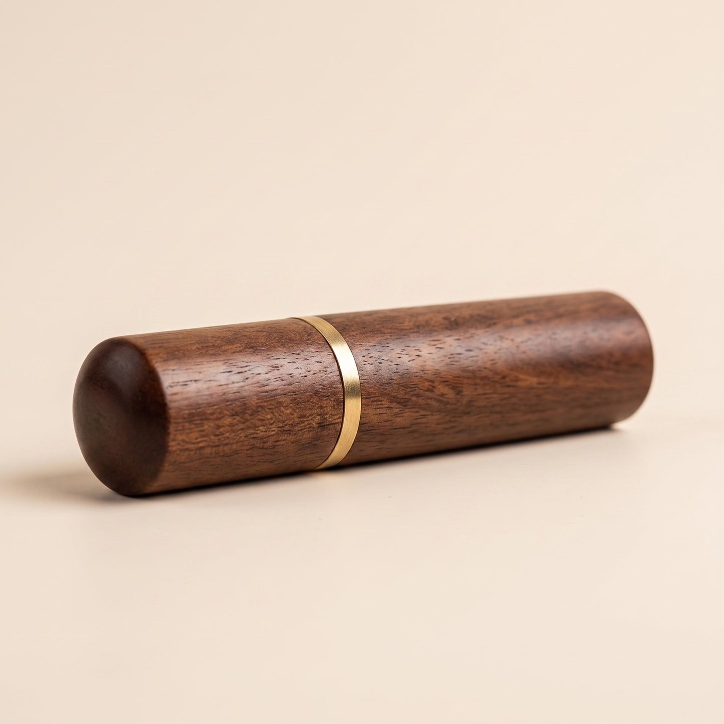 Wood WDT tool beside its brass-socket storage case, deep tone, profile view