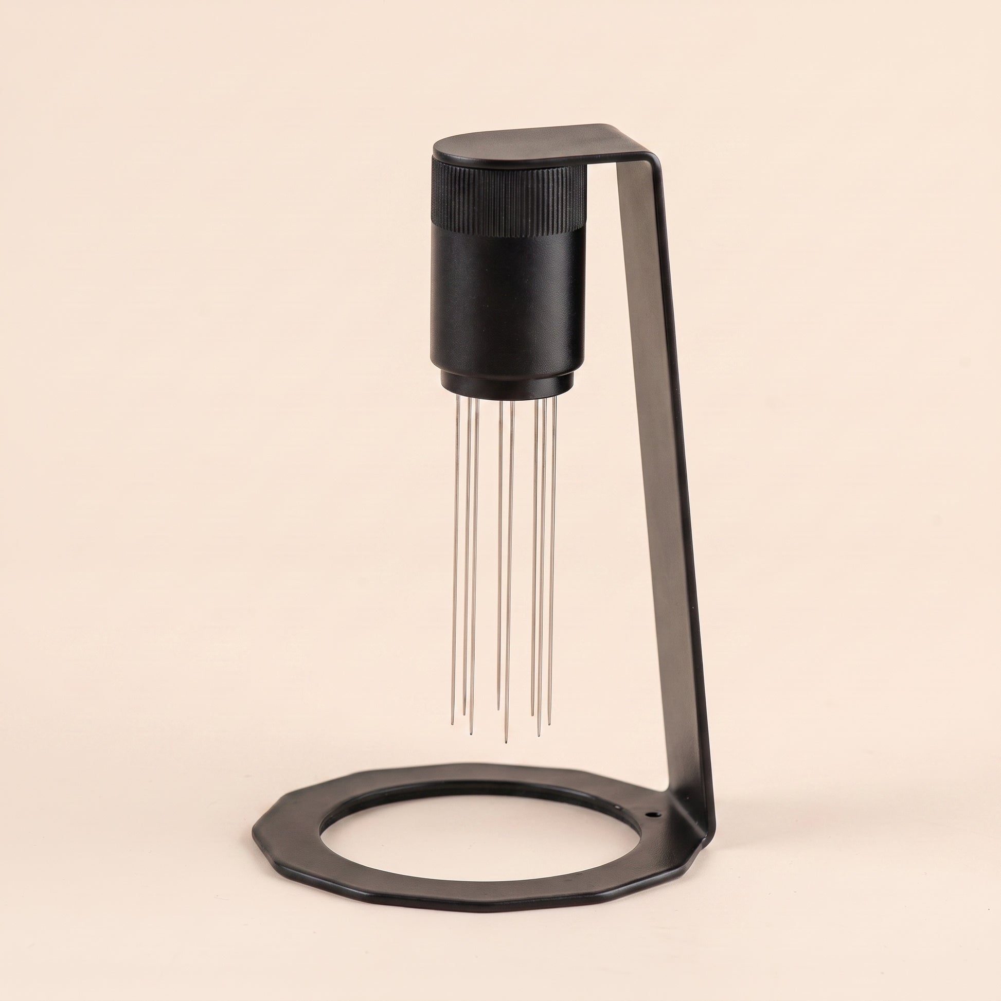 WDT tool parked on its magnetic stand, side profile, matte black metal base