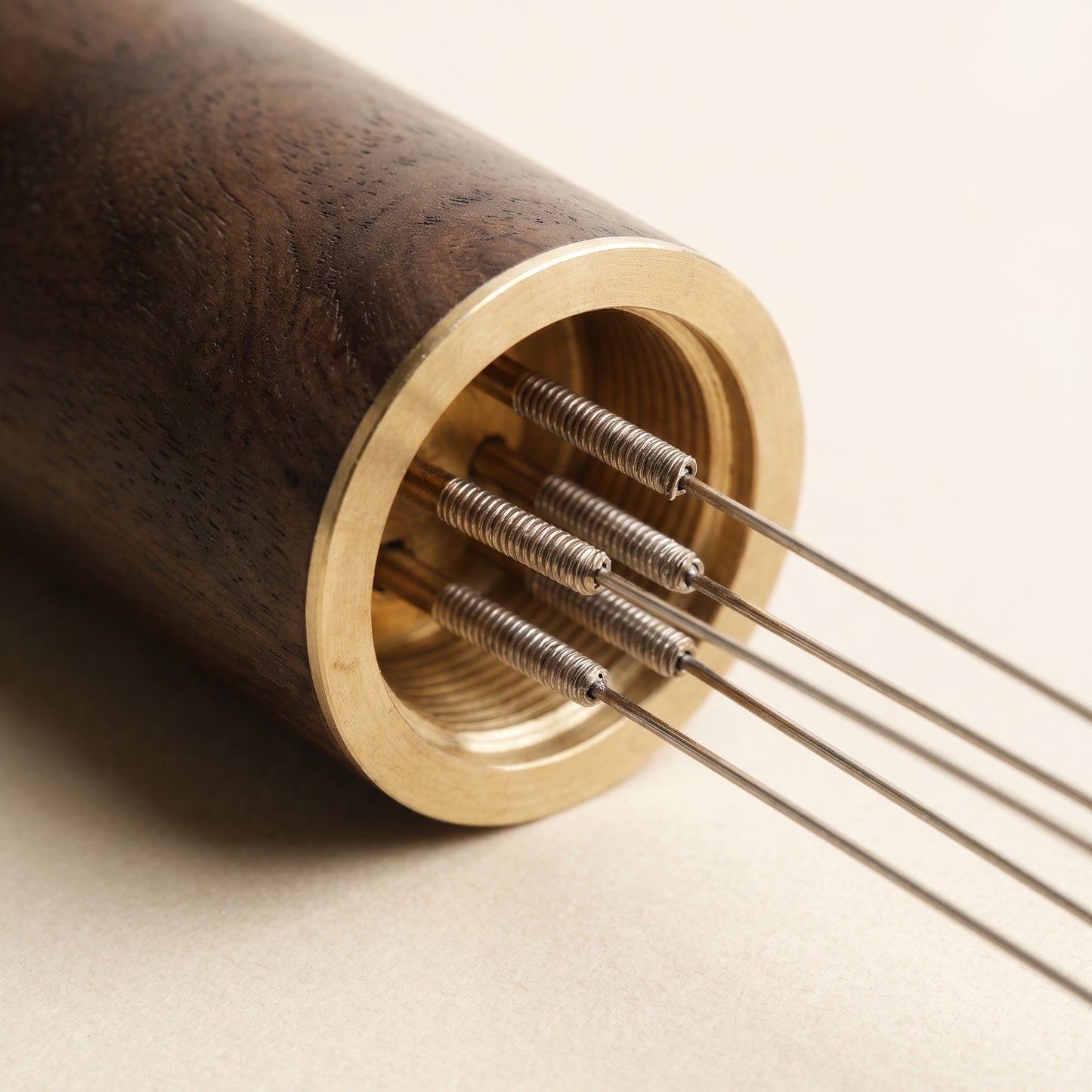 Close-up of the WDT tool's five fine needles set into a brass collar