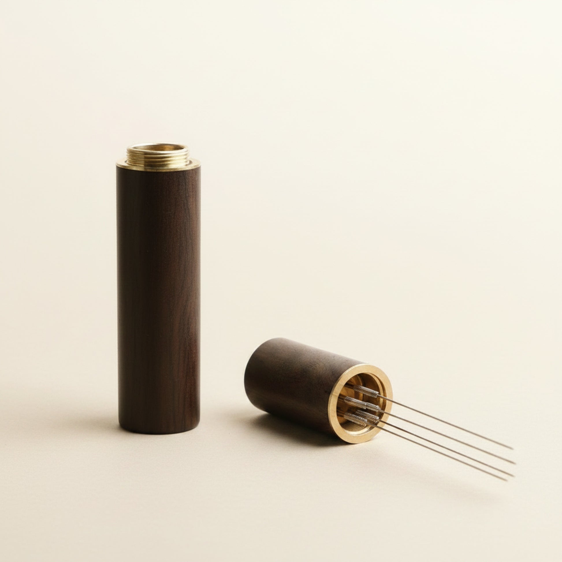 WDT tool with dark wood handle, front view on cream background, five fine needles for espresso distribution
